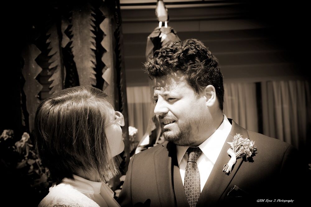 A wedding couple facing one another in black and white
