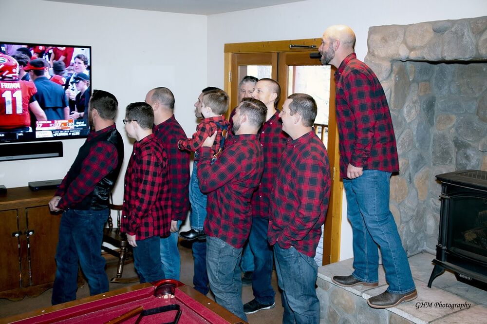 A family in matching plaid shirts gathered together for a celebration