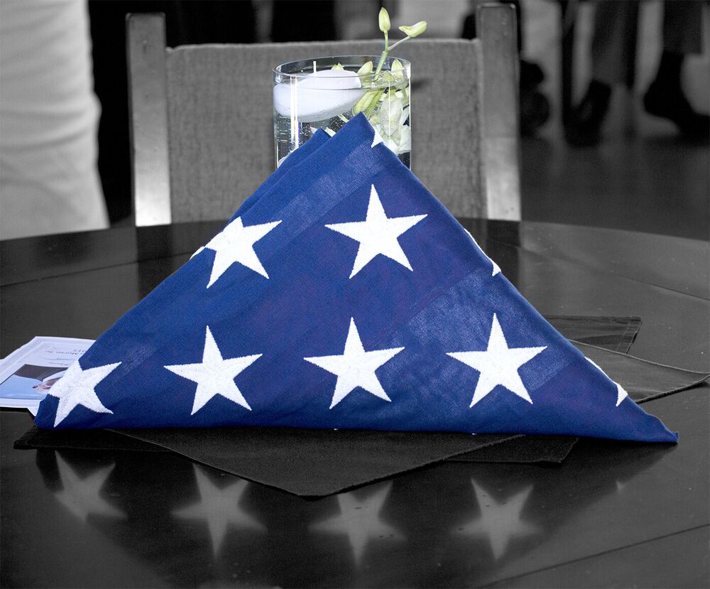 A folded American flag arranged for a memorial tribute