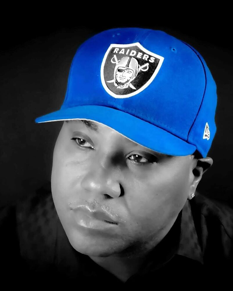 Monochrome portrait of a person wearing a blue cap