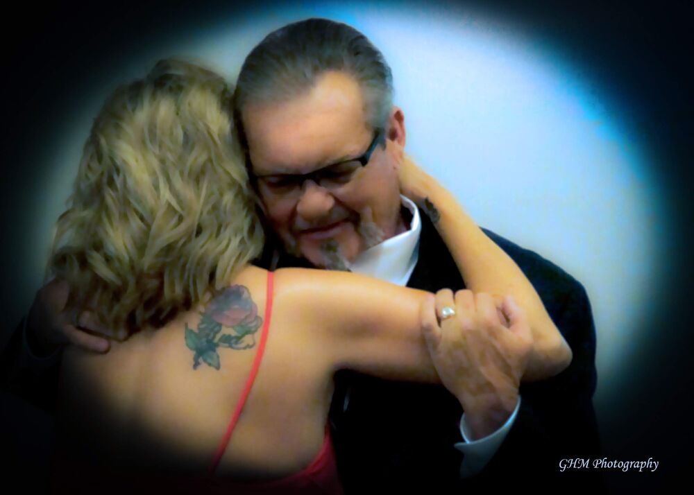 A couple sharing a close dance at a celebration