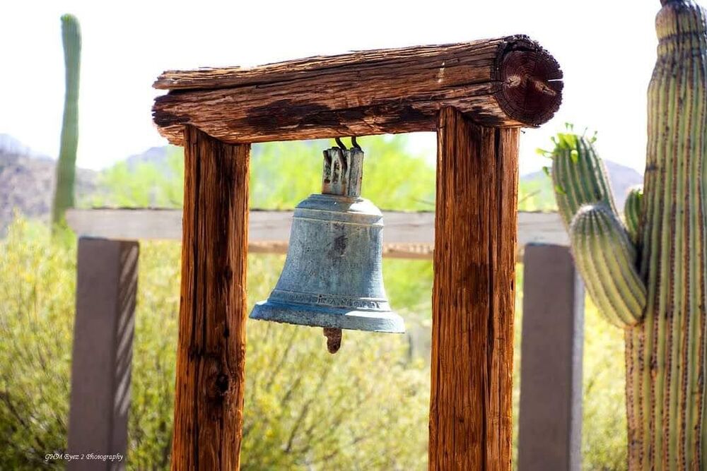 A weathered wooden bell frame in the Arizona desert