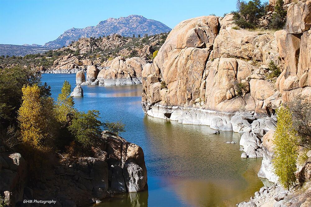 Blue water winding between granite formations at Watson Lake